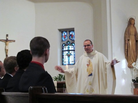 Fr. Eric Andrews delivers encouraging words to the novices during his homily at the First Promises Mass.