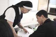 nun teaching boy
